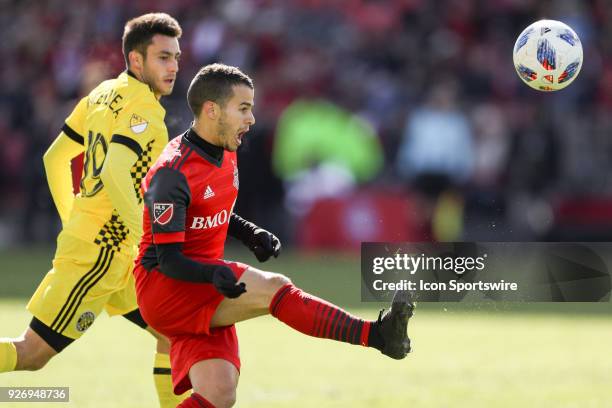 Toronto FC Forward Sebastian Giovinco kicks the ball as Columbus Crew SC Defender Milton Valenzuela looks on during the MLS regular season Toronto FC...