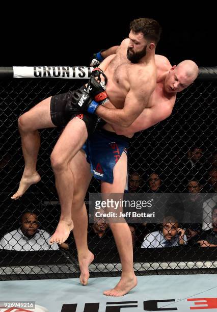 Stefan Struve of The Netherlands attempts to take down Andrei Arlovski of Belarus in their heavyweight bout during the UFC 222 event inside T-Mobile...