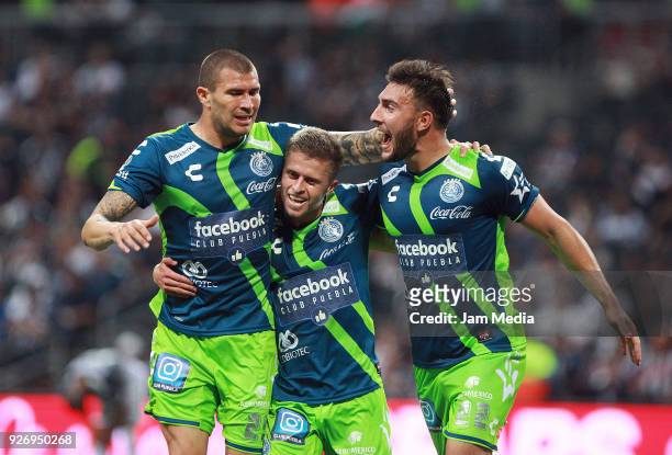 Jorge Enriquez Diego Cruz of Puebla and Lucas Cavallini of Puebla celebrate the third goal of their team, during the 10th round match between...