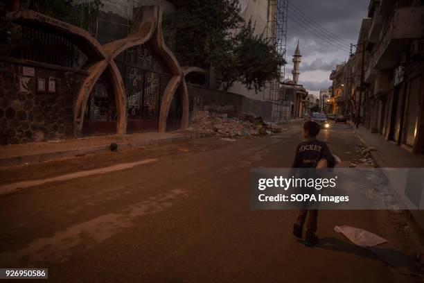 Boy walks by a Homs Christian church, damaged during fighting. The city of Homs which is located in the center of Syria was once a anti Assad...