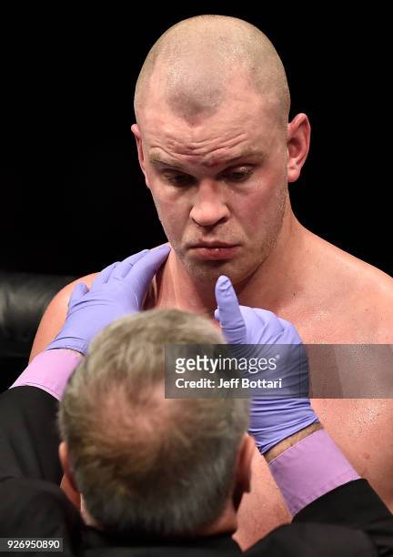 Stefan Struve of The Netherlands is checked by the doctor after being poked in the eye by Andrei Arlovski of Belarus in their heavyweight bout during...