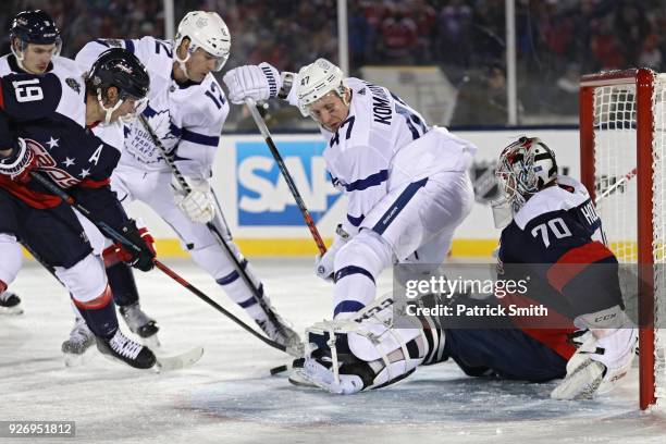 Goalie Braden Holtby of the Washington Capitals makes a save on Leo Komarov of the Toronto Maple Leafs during the third period in the Coors Light NHL...