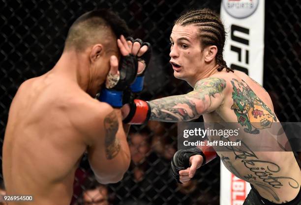 Sean O'Malley punches Andre Soukhamthath in their bantamweight bout during the UFC 222 event inside T-Mobile Arena on March 3, 2018 in Las Vegas,...