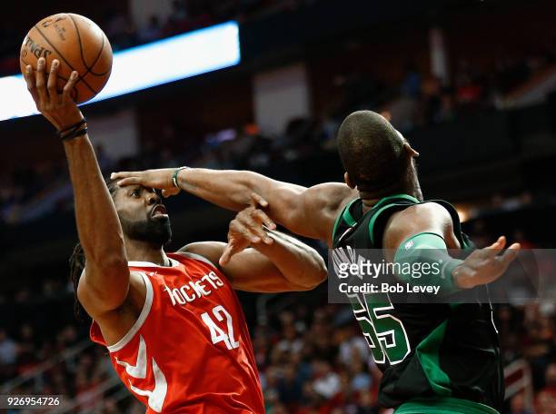 Nene of the Houston Rockets drives to the basket as Greg Monroe of the Boston Celtics defends at Toyota Center on March 3, 2018 in Houston, Texas....