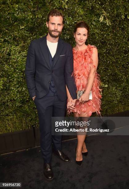 Jamie Dornan and Amelia Warner attend Charles Finch and Chanel Pre-Oscar Awards Dinner at Madeo in Beverly Hills on March 3, 2018 in Beverly Hills,...