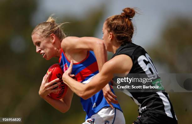 Lauren Spark of the Western Bulldogs is tackled by Emma King of the Magpies during the round five AFLW match between the Collingwood Magpies and the...