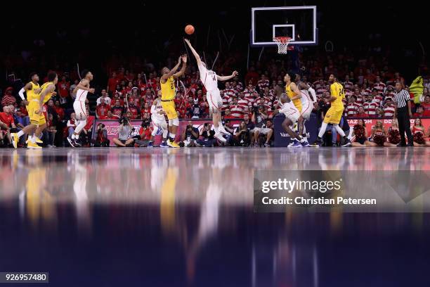 Dusan Ristic of the Arizona Wildcats and Kingsley Okoroh of the California Golden Bears jump for a rebound during the second half of the college...