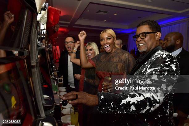 Sam and Jessica Slater and NeNe and Gregg Leakes play slot machines at the Lenny Zakim Fund's 9th Annual Casino Night to raise money to support more...