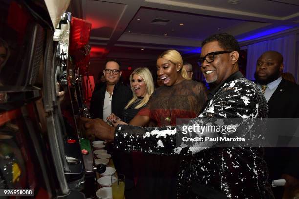 Sam and Jessica Slater and NeNe and Gregg Leakes play slot machines at the Lenny Zakim Fund's 9th Annual Casino Night to raise money to support more...