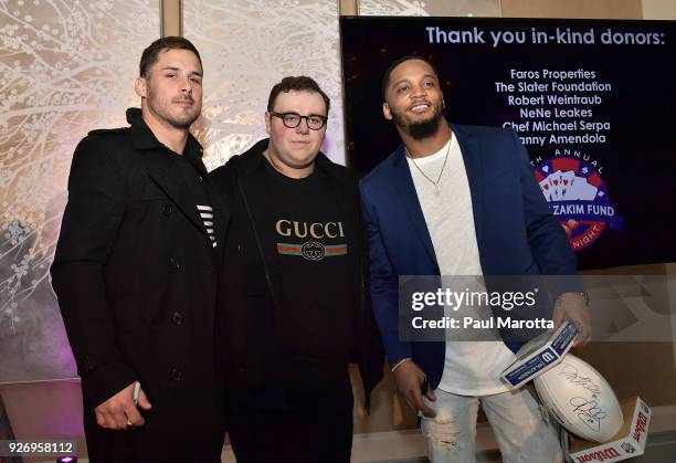 Danny Amendola and Patrick Chung autograph footballs to raise money at the Lenny Zakim Fund's 9th Annual Casino Night to raise money to support more...