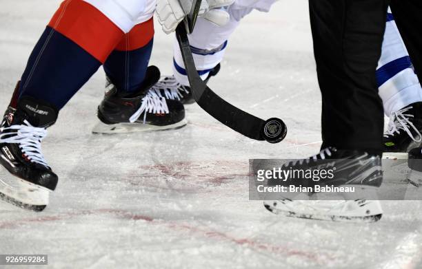 Detailed view of a puck is seen on a stick during a face-off during the 2018 Coors Light NHL Stadium Series game between the Toronto Maple Leafs and...