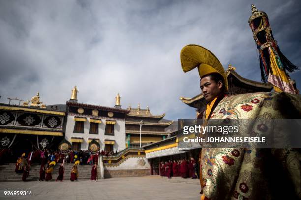 This picture taken on March 1, 2018 shows Tibetan Buddhist monks praying during a ceremony for Monlam, otherwise known as the Great Prayer Festival...