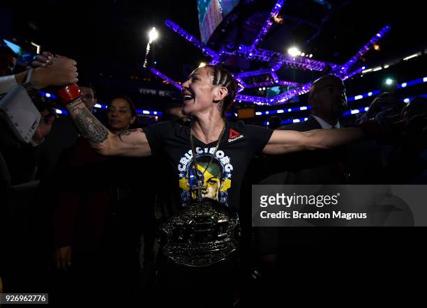 Cris Cyborg of Brazil celebrates after her TKO victory over Yana Kunitskaya of Russia in their women's featherweight bout during the UFC 222 event...