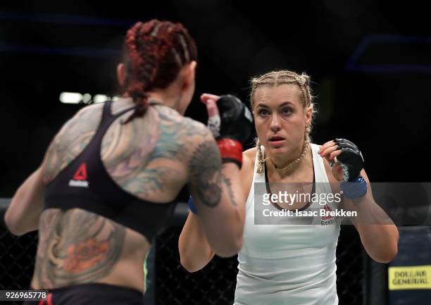 Cris Cyborg and Yana Kunitskaya fight during their women's featherweight title bout during UFC 222 at T-Mobile Arena on March 3, 2018 in Las Vegas,...