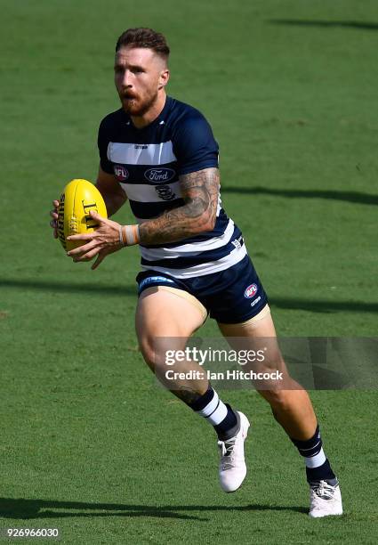 Zach Tuohy of the Cats runs the ball during the AFL JLT Community Series match between the Geelong Cats and the Gold Coast Suns at Riverway Stadium...