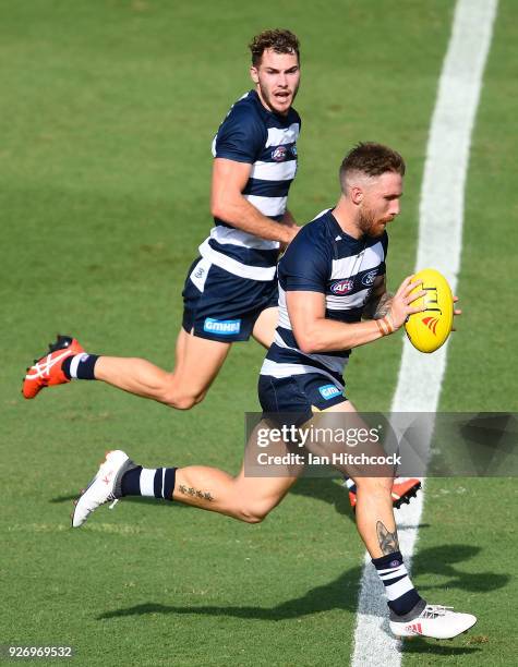 Zach Tuohy of the Cats runs the ball during the AFL JLT Community Series match between the Geelong Cats and the Gold Coast Suns at Riverway Stadium...