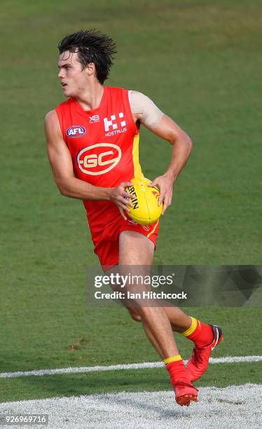 Jack Bowes of the Suns runs the ball during the AFL JLT Community Series match between the Geelong Cats and the Gold Coast Suns at Riverway Stadium...