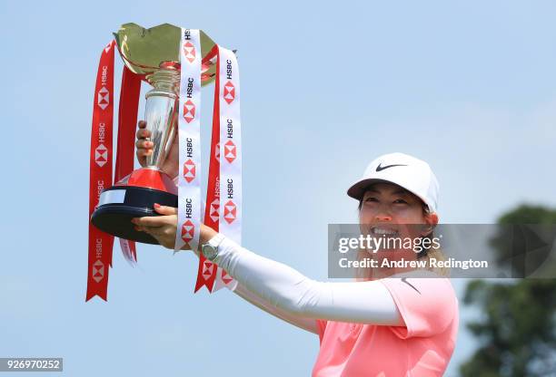 Michelle Wie of the United States celebrates with the winner's trophy after the final round of the HSBC Women's World Championship at Sentosa Golf...