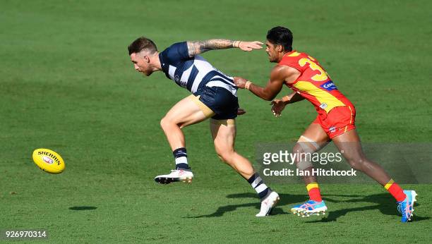 Zach Tuohy of the Cats and Aaron Hall of the Suns contest the ball during the AFL JLT Community Series match between the Geelong Cats and the Gold...