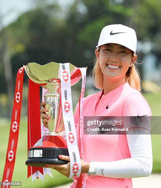 Michelle Wie of the United States celebrates with the winner's trophy after the final round of the HSBC Women's World Championship at Sentosa Golf...