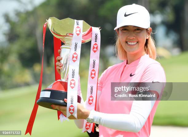 Michelle Wie of the United States celebrates with the winner's trophy after the final round of the HSBC Women's World Championship at Sentosa Golf...