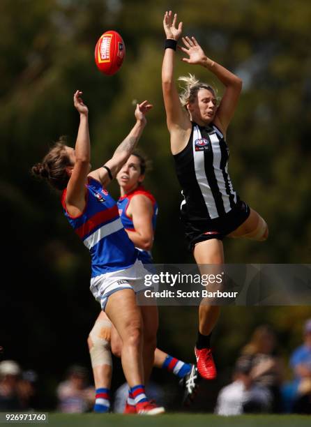 Ellie Blackburn of the Bulldogs and Christina Bernardi of the Magpies compete for the ball during the round five AFLW match between the Collingwood...