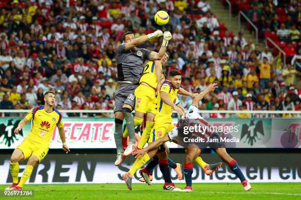 Rodolfo Cota of Chivas and Paul Aguilar of America jump for the ball during the 10th round match between Chivas and America as part of the Torneo...