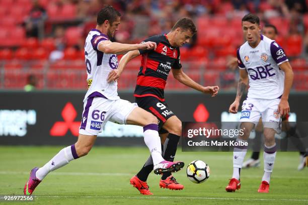 Dino Djulbic of the Glory and Oriol Riera of the Wanderers compete for the ball during the round 23 A-League match between the Western Sydney...