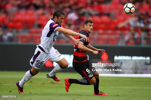 Dino Djulbic of the Glory and Oriol Riera of the Wanderers compete for the ball during the round 23 A-League match between the Western Sydney...