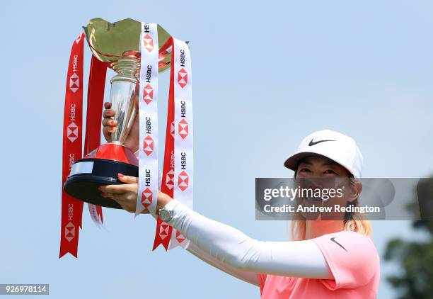 Michelle Wie of the United States celebrates with the winner's trophy after the final round of the HSBC Women's World Championship at Sentosa Golf...