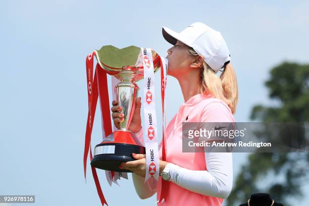Michelle Wie of the United States celebrates with the winner's trophy after the final round of the HSBC Women's World Championship at Sentosa Golf...