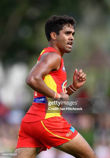 Jack Martin of the Suns runs the ball during the AFL JLT Community Series match between the Geelong Cats and the Gold Coast Suns at Riverway Stadium...