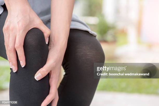 female athlete runner touching knee in pain, fitness woman running in summer park. healthy lifestyle and sport concept. - swollen ankles stock pictures, royalty-free photos & images