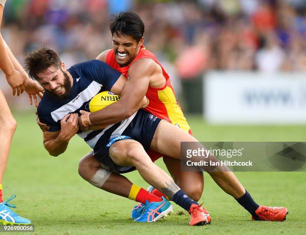 Aaron Hall of the Suns tackles James Parsons of the Cats during the AFL JLT Community Series match between the Geelong Cats and the Gold Coast Suns...