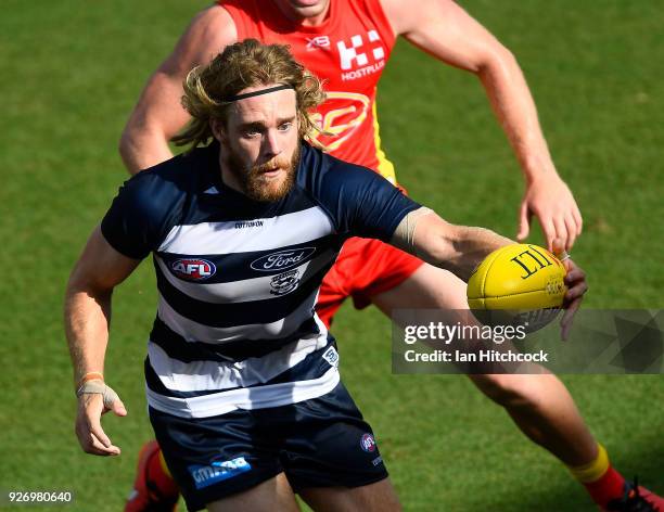 Cameron Guthrie of the Cats gathers the ball during the AFL JLT Community Series match between the Geelong Cats and the Gold Coast Suns at Riverway...