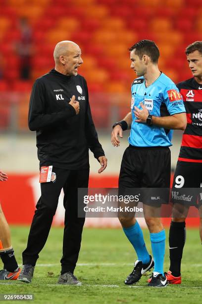 Glory coach Kenneth Lowe speaks to referee Jarred Gillett after the match during the round 23 A-League match between the Western Sydney Wanderers and...