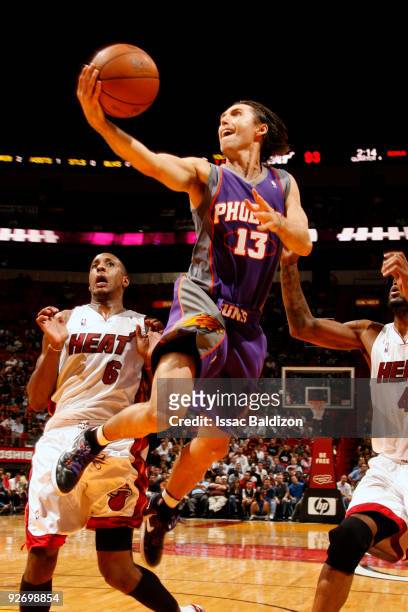 Steve Nash of the Phoenix Suns shoots against Mario Chalmers and Udonis Haslem of the Miami Heat on November 3, 2009 at American Airlines Arena in...