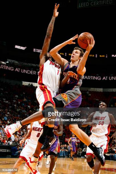 Goran Dragic of the Phoenix Suns shoots against Dorell Wright of the Miami Heat on November 3, 2009 at American Airlines Arena in Miami, Florida....