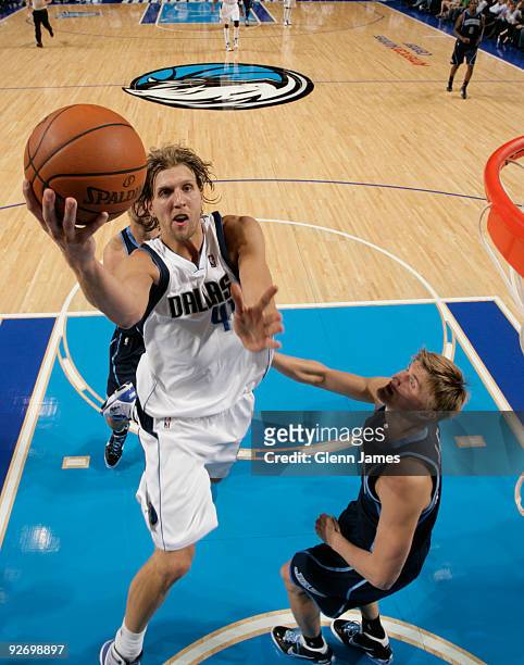 Dirk Nowitzki of the Dallas Mavericks goes in for the layup against Andrei Kirilenko of the Utah Jazz during a game at the American Airlines Center...