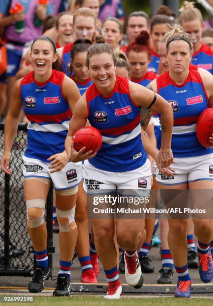 Ellie Blackburn of the Bulldogs leads her team onto the field during the 2018 AFLW Round 05 match between the Collingwood Magpies and the Western...