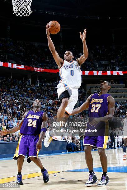 Russell Westbrook of the Oklahoma City Thunder goes to the basket against Kobe Bryan and Ron Artest of the Los Angeles Lakers on November 3, 2009 at...