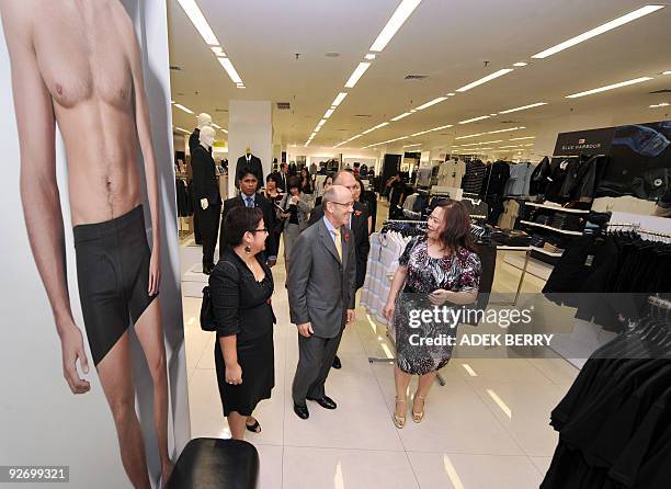 British Minister for Trade, Investment and Small Business Mervyn Davies visits a Mark and Spencer retail shop at the Plaza Indonesia shopping center...