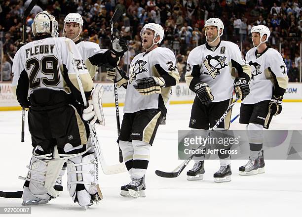 Pittsburgh Penguins goaltender Marc-Andre Fleury is congratulated by Pascal Dupuis, Matt Cooke, Bill Guerin and Mark Eaton following the Penguins...
