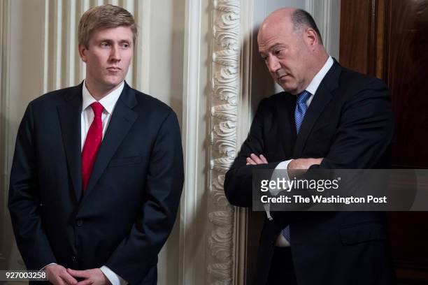 Chief of Staff to Vice President Pence Nick Ayers, left, and White House chief economic adviser Gary Cohn, listen as President Donald Trump speaks at...