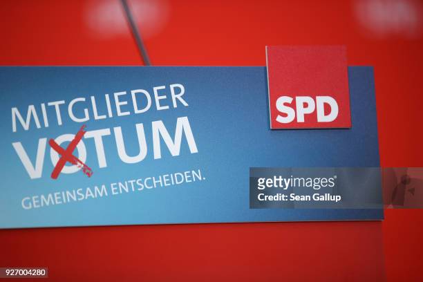 Sign of the German Social Democrats that reads: "Member Vote" hnags froma speaker's podium shortly before party officials announced the result of the...
