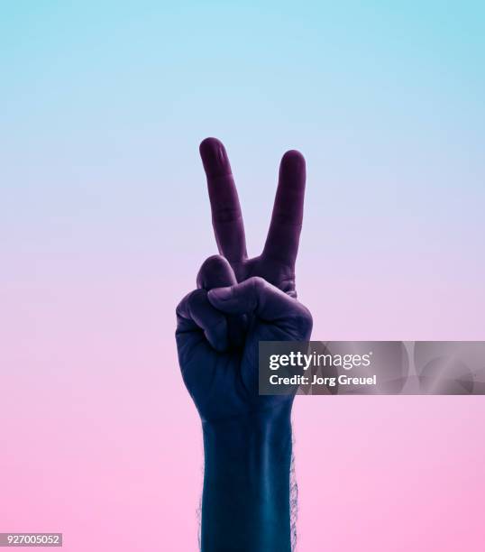 male hand showing victory/peace sign - victory sign stock-fotos und bilder