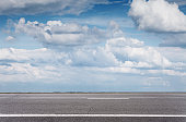 Empty asphalt road over blue sky, side view