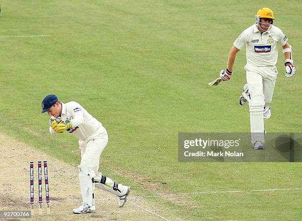 Brad Haddin of the Blues runs out Ashley Noffke of the Warriors during day two of the Sheffield Shield match between the New South Wales Blues and...