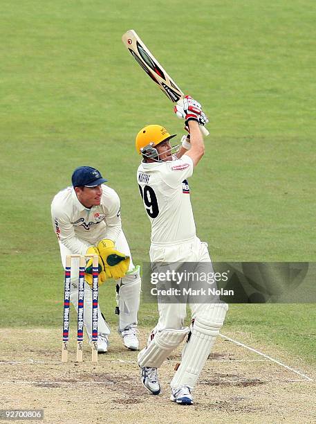 Ashley Noffke of the Warriors hits a boundary during day two of the Sheffield Shield match between the New South Wales Blues and the Western...