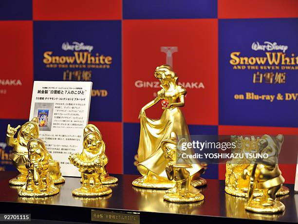 Pure gold Disney character dolls are displayed showing Snow White and the seven dwarfs, priced at 30 million yen and produced by Tanaka Kikinzoku...